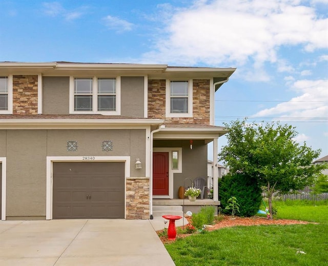 28340 W 164th St, Gardner, KS 66030 - prairie-style house featuring stone siding, stucco siding, a garage, and driveway
