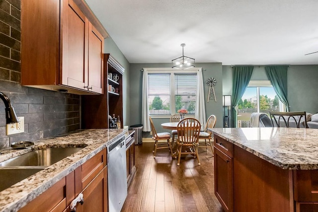28340 W 164th St, Gardner, KS 66030 - kitchen with stainless steel dishwasher, a sink, brown cabinetry, dark wood-type flooring, and decorative backsplash