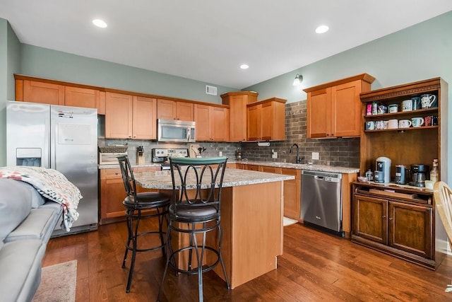28340 W 164th St, Gardner, KS 66030 - kitchen featuring appliances with stainless steel finishes, decorative backsplash, a sink, a center island, and recessed lighting