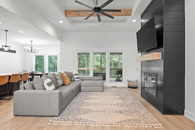 306 SW 17th St, Oak Grove, MO 64075 - living area with a large fireplace, recessed lighting, light wood-style floors, a raised ceiling, and a chandelier