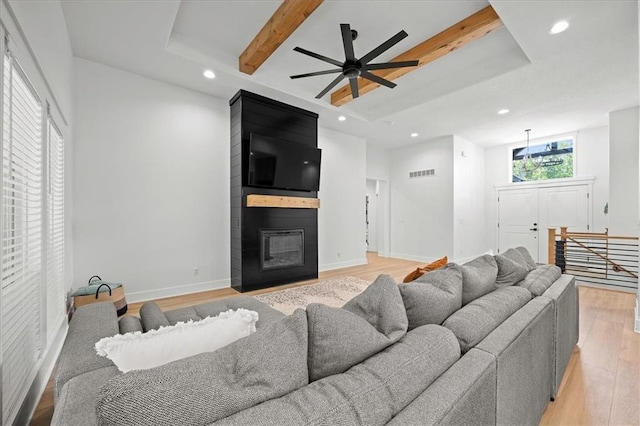 306 SW 17th St, Oak Grove, MO 64075 - living area featuring recessed lighting, light wood-style flooring, beam ceiling, a large fireplace, and a ceiling fan