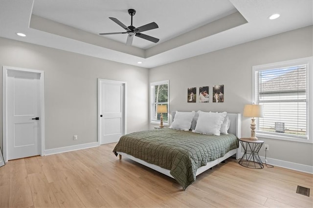 306 SW 17th St, Oak Grove, MO 64075 - bedroom with light wood-type flooring, a raised ceiling, recessed lighting, and ceiling fan
