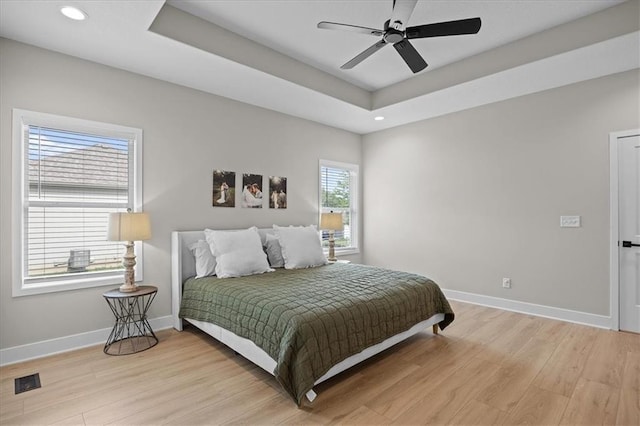 306 SW 17th St, Oak Grove, MO 64075 - bedroom featuring light wood-style floors, recessed lighting, a raised ceiling, and a ceiling fan