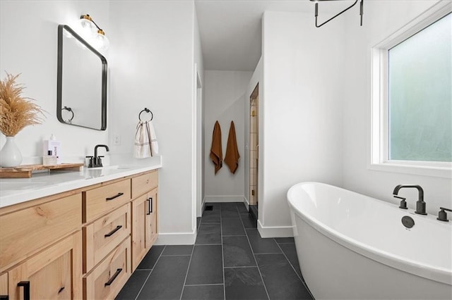306 SW 17th St, Oak Grove, MO 64075 - full bath with vanity, a freestanding tub, and tile patterned flooring