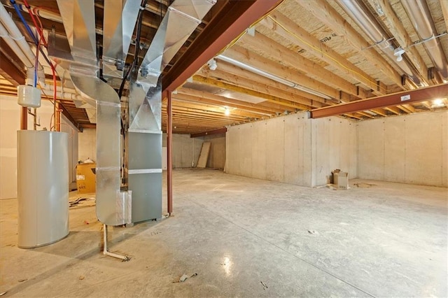 306 SW 17th St, Oak Grove, MO 64075 - unfinished below grade area featuring water heater and heating unit