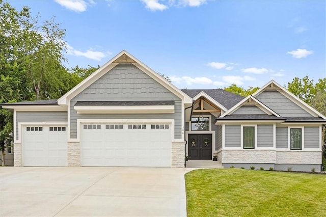 306 SW 17th St, Oak Grove, MO 64075 - craftsman inspired home featuring driveway, a garage, a front lawn, and stone siding