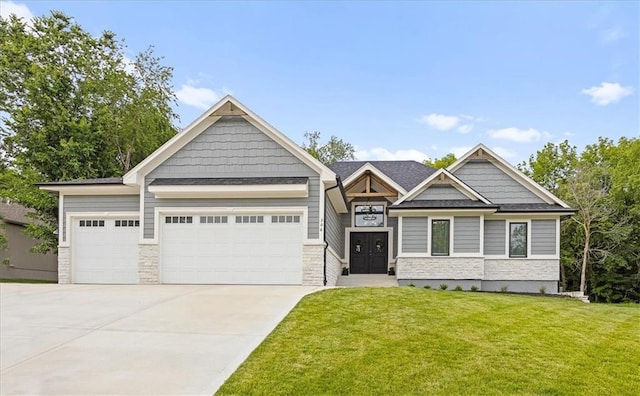 306 SW 17th St, Oak Grove, MO 64075 - craftsman-style home featuring concrete driveway, a front lawn, an attached garage, and stone siding