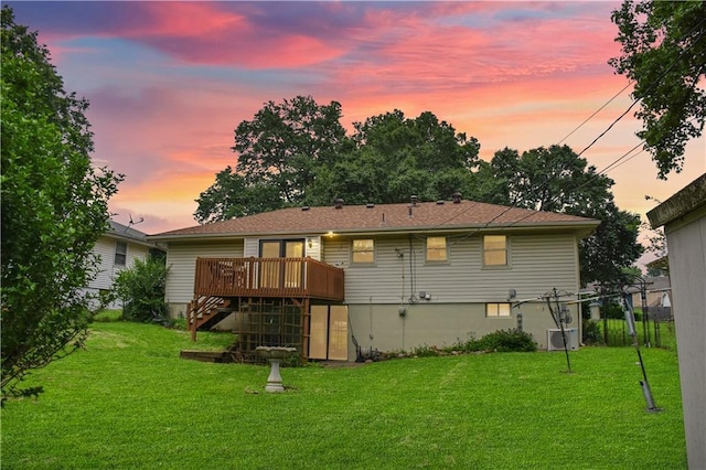13408 Winchester Ave, Grandview, MO 64030 - back of property at dusk with a deck, a yard, stairs, and central air condition unit