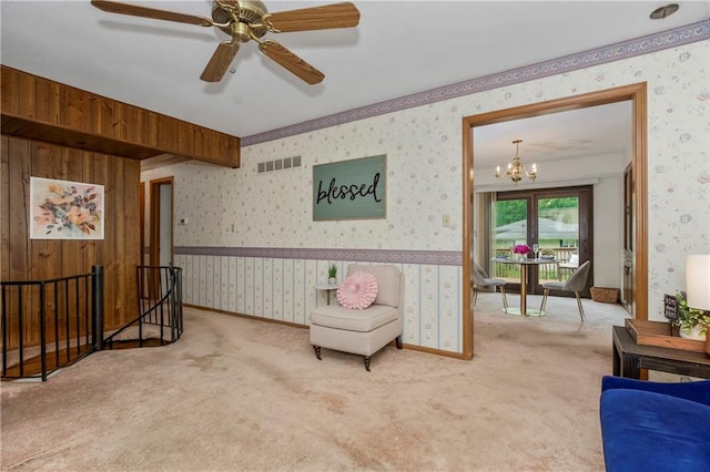 13408 Winchester Ave, Grandview, MO 64030 - living area featuring an upstairs landing, wallpapered walls, carpet, a chandelier, and a ceiling fan