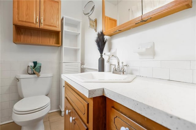 13408 Winchester Ave, Grandview, MO 64030 - bathroom with toilet, vanity, tile patterned floors, and tile walls
