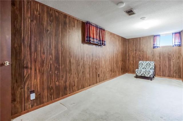 13408 Winchester Ave, Grandview, MO 64030 - below grade area with a textured ceiling, wooden walls, carpet flooring, and baseboards