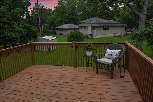 13408 Winchester Ave, Grandview, MO 64030 - deck at dusk featuring a yard and view of wooded area