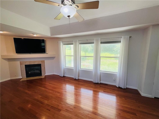 31821 159th St, Leavenworth, KS 66048 - unfurnished living room featuring wood-type flooring, a tile fireplace, plenty of natural light, and a ceiling fan