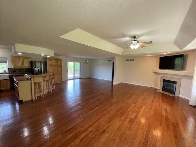 31821 159th St, Leavenworth, KS 66048 - unfurnished living room with a tile fireplace, a ceiling fan, and dark wood-style floors