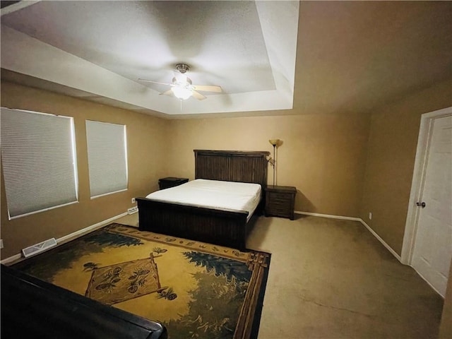 31821 159th St, Leavenworth, KS 66048 - carpeted bedroom featuring a tray ceiling and a ceiling fan