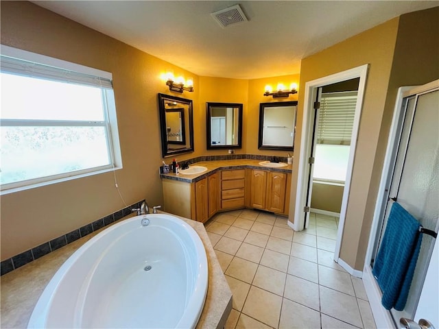 31821 159th St, Leavenworth, KS 66048 - bathroom featuring a bath, double vanity, a shower stall, and tile patterned floors
