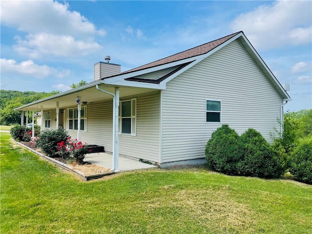31821 159th St, Leavenworth, KS 66048 - view of property exterior featuring a yard and a chimney