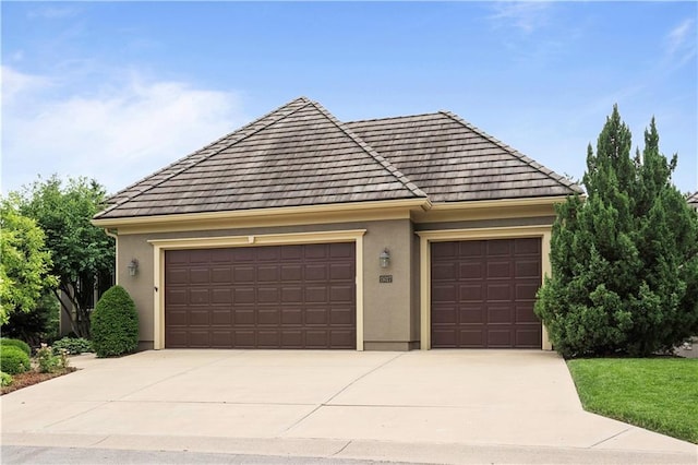15027 Ash St, Leawood, KS 66224 - view of front of house featuring stucco siding, concrete driveway, a garage, and a tiled roof