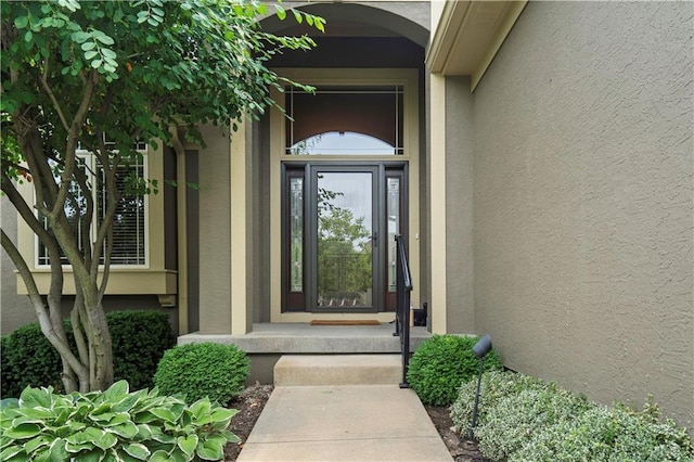 15027 Ash St, Leawood, KS 66224 - doorway to property with stucco siding