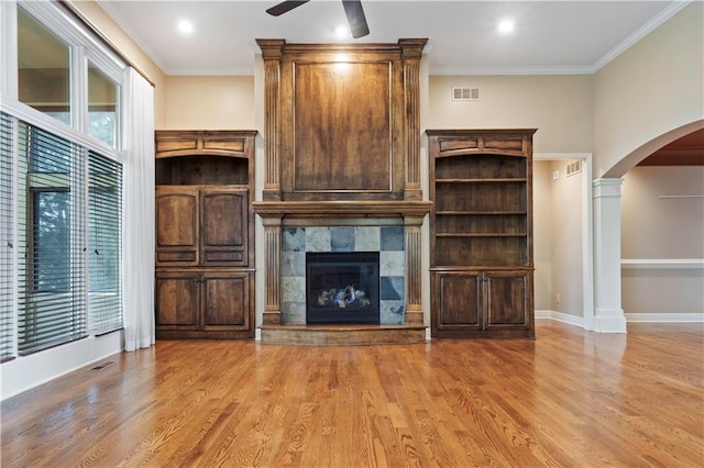15027 Ash St, Leawood, KS 66224 - unfurnished living room with arched walkways, wood finished floors, a ceiling fan, and crown molding