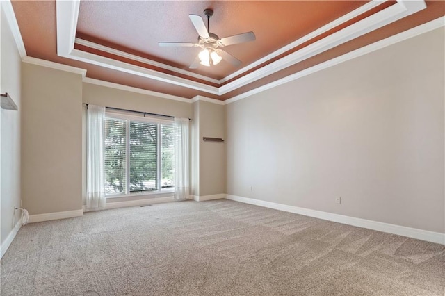 15027 Ash St, Leawood, KS 66224 - empty room featuring a tray ceiling, ornamental molding, carpet floors, and a ceiling fan
