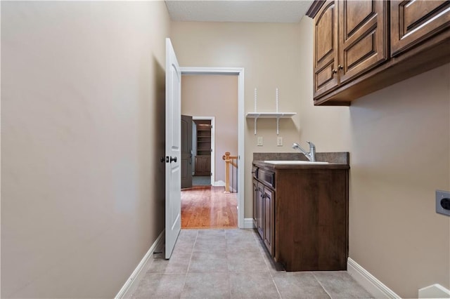 15027 Ash St, Leawood, KS 66224 - laundry room featuring cabinet space, hookup for an electric dryer, and light tile patterned floors