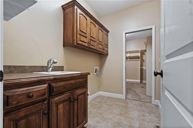 15027 Ash St, Leawood, KS 66224 - washroom featuring cabinet space, washer hookup, and light tile patterned floors