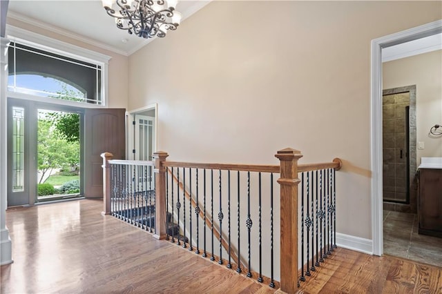 15027 Ash St, Leawood, KS 66224 - foyer entrance with a chandelier, wood finished floors, crown molding, and a towering ceiling