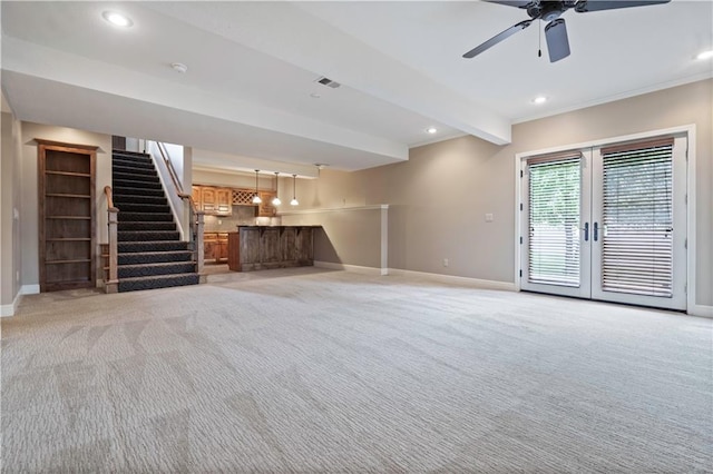 15027 Ash St, Leawood, KS 66224 - unfurnished living room with stairs, light carpet, bar, french doors, and recessed lighting