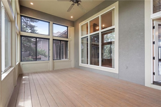 15027 Ash St, Leawood, KS 66224 - unfurnished sunroom with a ceiling fan, wood-type flooring, plenty of natural light, a textured wall, and recessed lighting