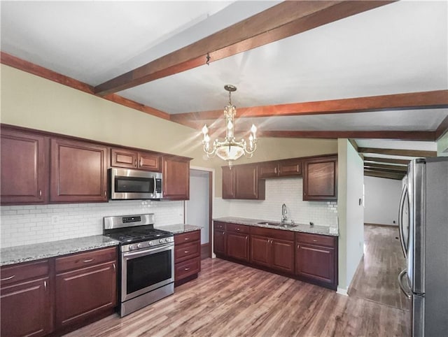 2939 Jewett St, Kansas City, MO 64117 - kitchen featuring stainless steel appliances, a sink, beamed ceiling, a chandelier, and decorative backsplash