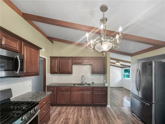 2939 Jewett St, Kansas City, MO 64117 - kitchen with stainless steel appliances, a sink, a chandelier, beam ceiling, and tasteful backsplash