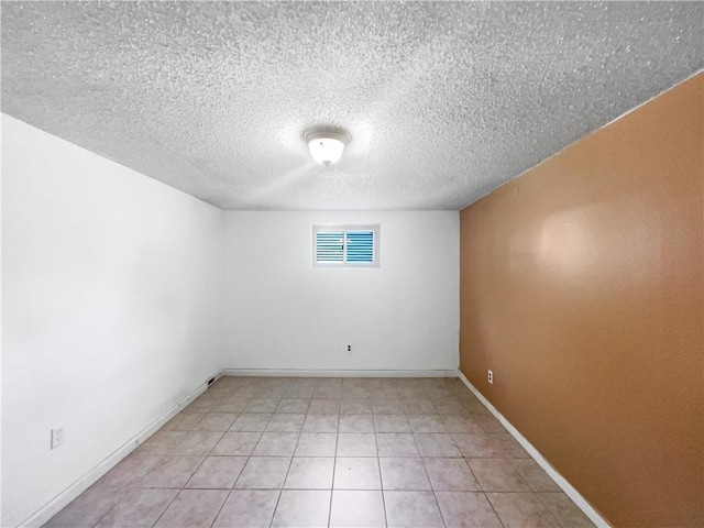 2939 Jewett St, Kansas City, MO 64117 - empty room featuring a textured ceiling, light tile patterned floors, and baseboards
