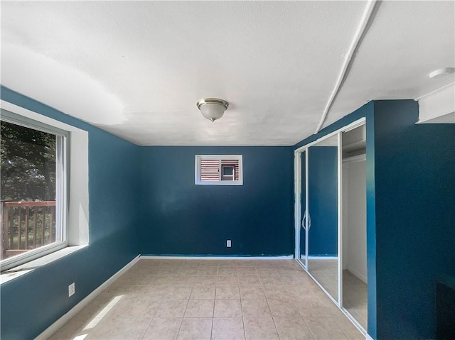 2939 Jewett St, Kansas City, MO 64117 - unfurnished bedroom with baseboards, a closet, and tile patterned flooring