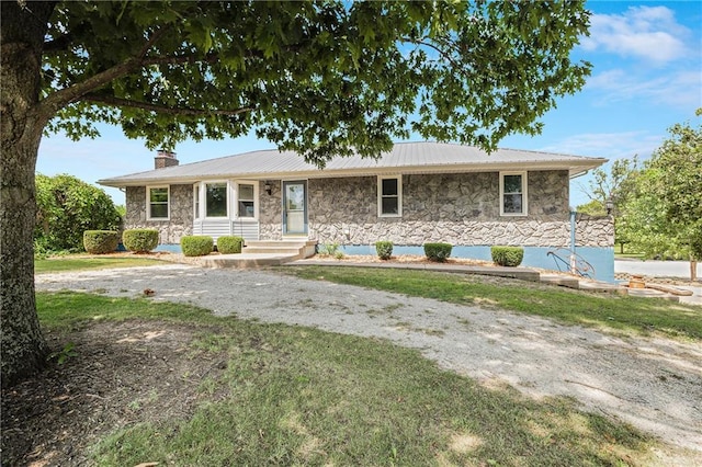 160 SW 131st Hwy, Holden, MO 64040 - ranch-style home with stone siding, a chimney, and a metal roof