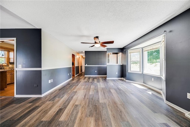 160 SW 131st Hwy, Holden, MO 64040 - unfurnished living room featuring a ceiling fan, wood finished floors, and a textured ceiling