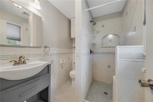 160 SW 131st Hwy, Holden, MO 64040 - full bathroom featuring tile walls, a tile shower, vanity, tile patterned flooring, and a wainscoted wall