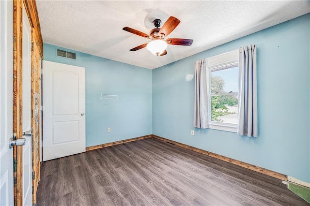 160 SW 131st Hwy, Holden, MO 64040 - spare room with dark wood-style floors, a ceiling fan, and a textured ceiling