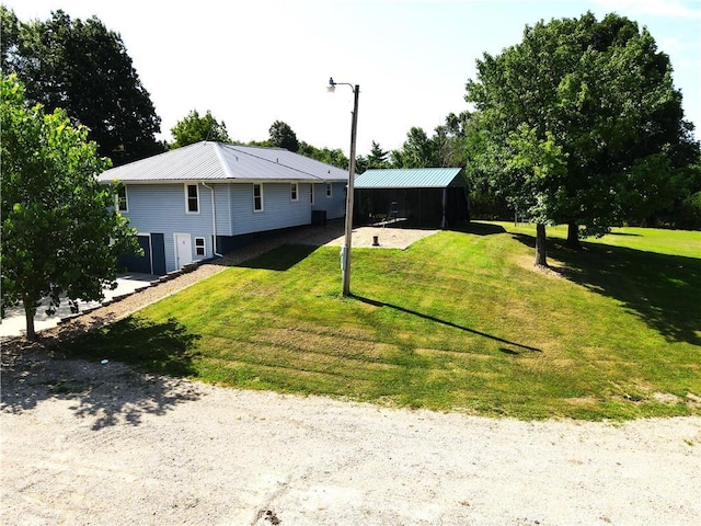 160 SW 131st Hwy, Holden, MO 64040 - rear view of property featuring a lawn and a metal roof