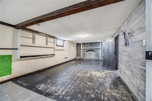 160 SW 131st Hwy, Holden, MO 64040 - unfurnished living room with a textured ceiling, a fireplace, and wood walls