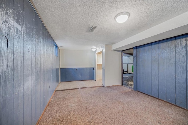 160 SW 131st Hwy, Holden, MO 64040 - spare room with wood walls, a textured ceiling, and carpet