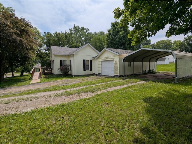 225 E 11th St, Horton, KS 66439 - view of front of home with a front yard, driveway, a detached carport, and a deck