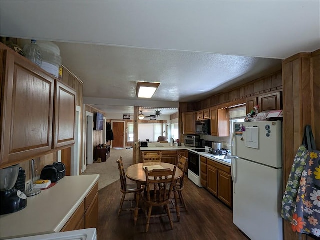 225 E 11th St, Horton, KS 66439 - kitchen with freestanding refrigerator, range with electric stovetop, dark wood-style floors, and light countertops