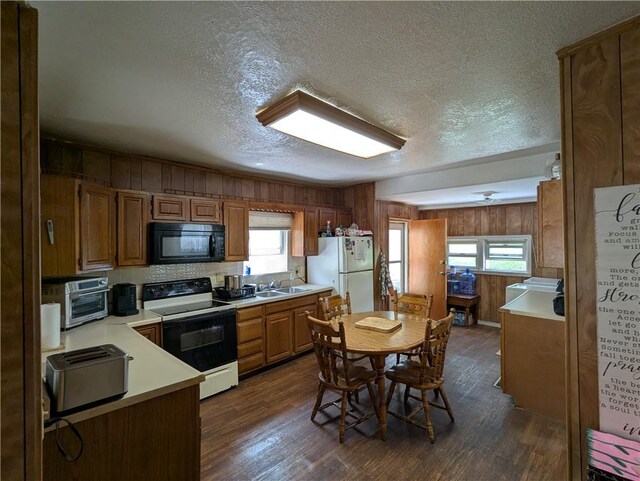225 E 11th St, Horton, KS 66439 - kitchen with range with electric cooktop, black microwave, freestanding refrigerator, a sink, and a textured ceiling