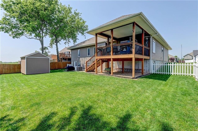 966 Moore Pl, Odessa, MO 64076 - back of house featuring a fenced backyard, a storage unit, stairs, and a deck