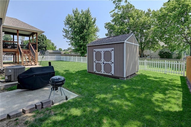 966 Moore Pl, Odessa, MO 64076 - fenced backyard featuring stairway, a storage unit, a patio, and a wooden deck
