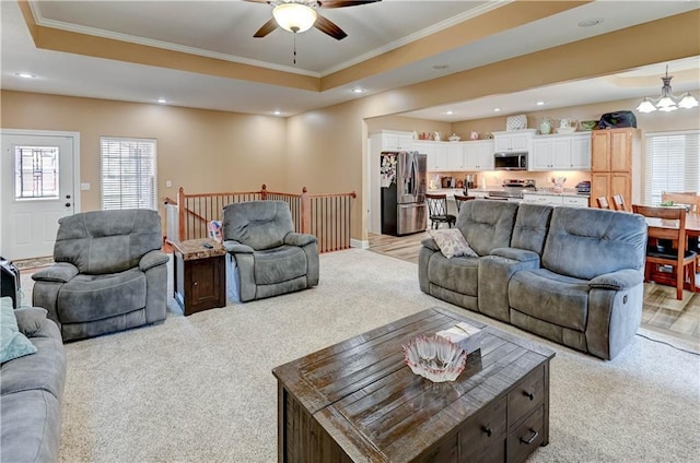 966 Moore Pl, Odessa, MO 64076 - living area with light carpet, ornamental molding, plenty of natural light, a ceiling fan, and recessed lighting
