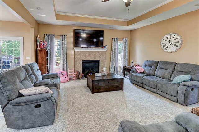 966 Moore Pl, Odessa, MO 64076 - living room featuring crown molding, ceiling fan, carpet flooring, a glass covered fireplace, and a raised ceiling