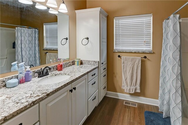966 Moore Pl, Odessa, MO 64076 - full bathroom featuring wood finished floors, vanity, and a shower with curtain
