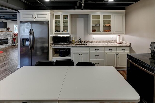 966 Moore Pl, Odessa, MO 64076 - kitchen with range with electric cooktop, fridge with ice dispenser, stainless steel microwave, dark wood-style floors, and white cabinets